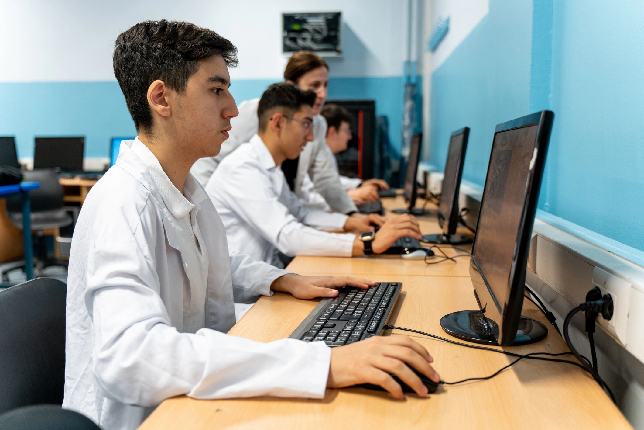 Students learning computer programming in class