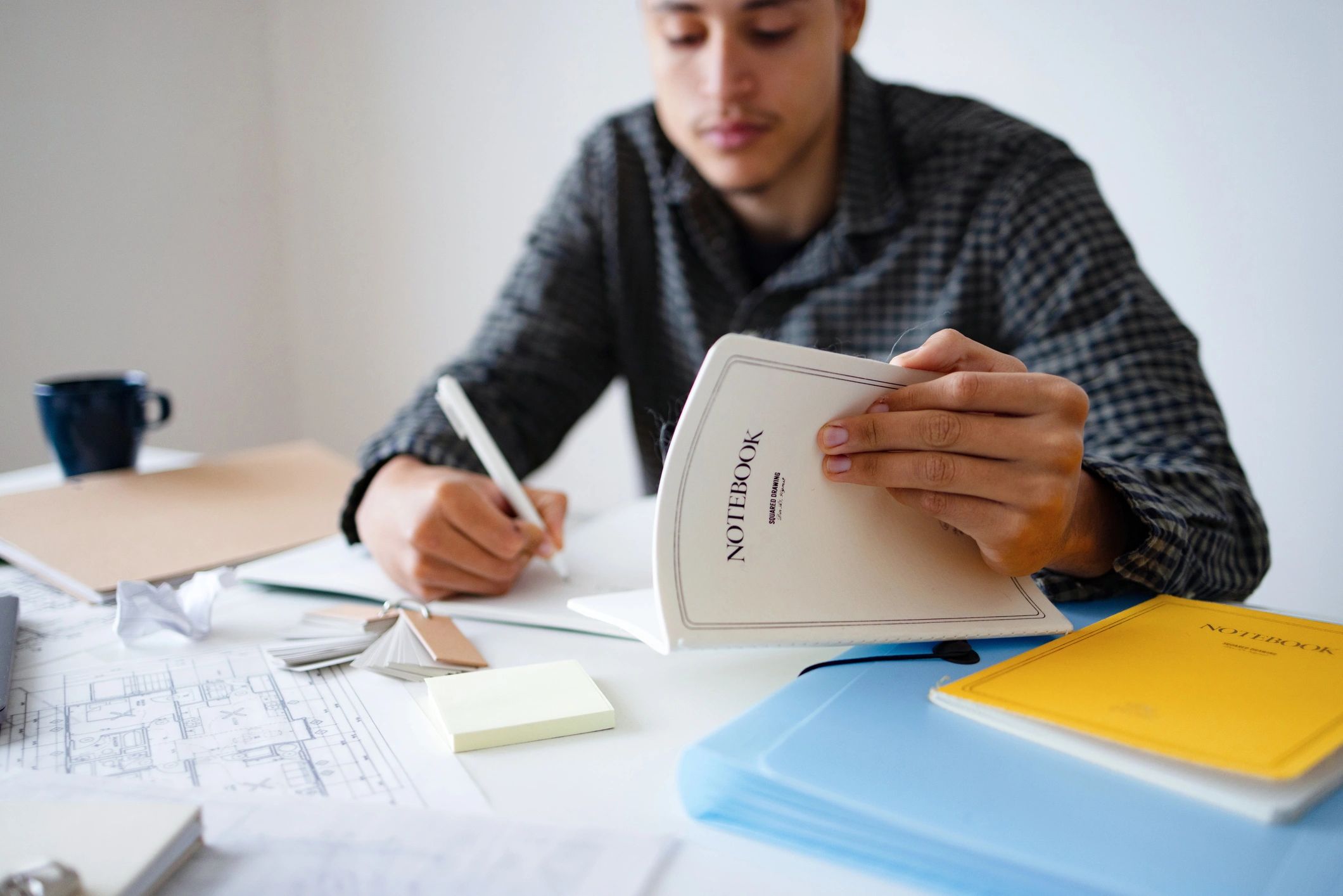 Student writing notes while studying